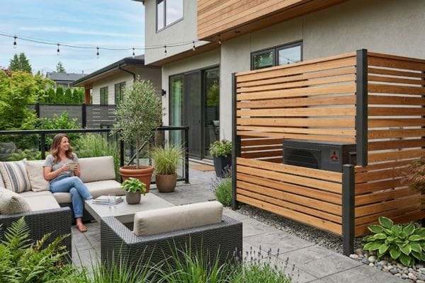 Modern cedar slatted wood screen designed to hide outdoor AC unit next to a house